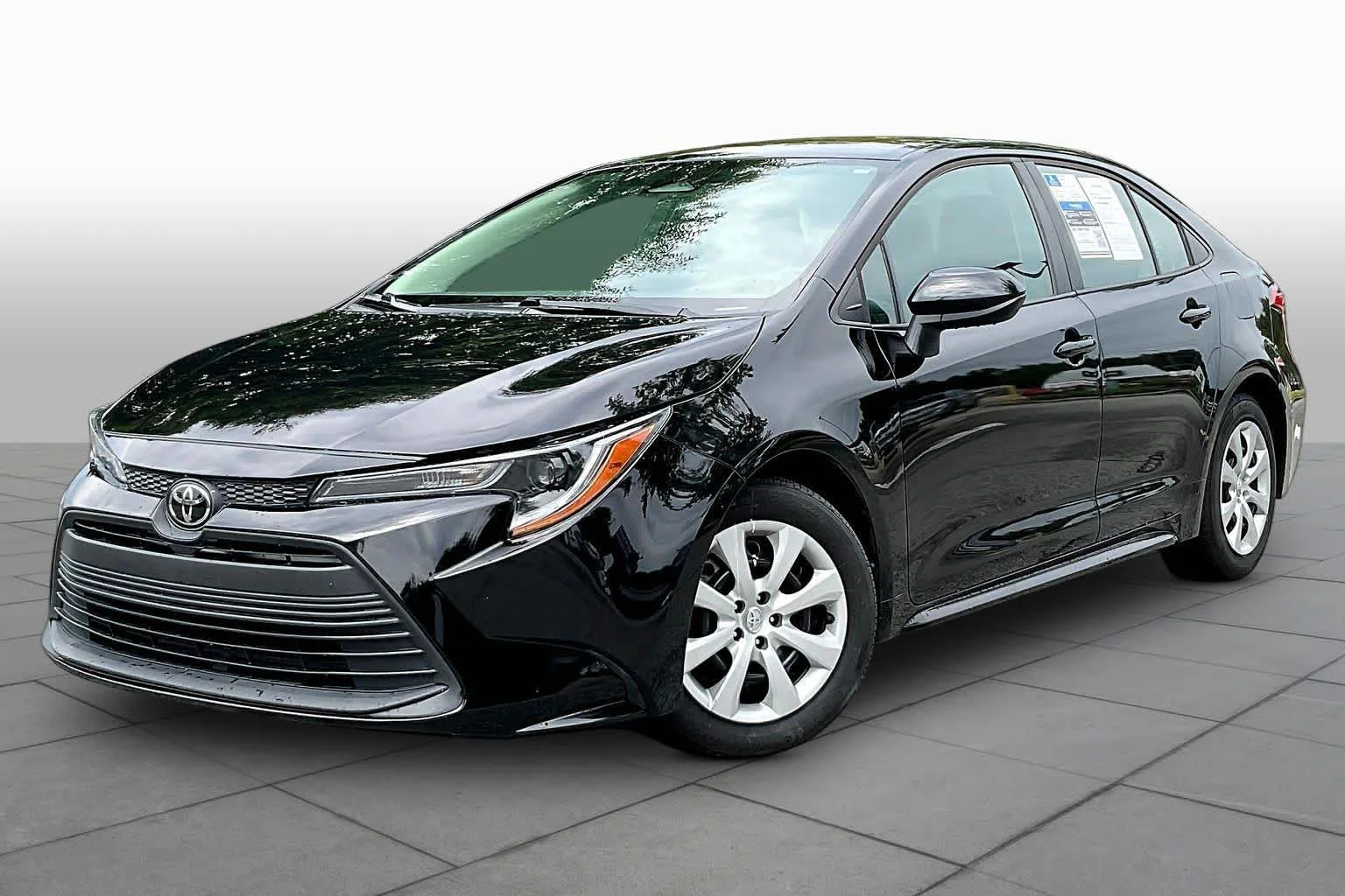 Used 2024 Midnight Black Metallic Toyota LE image 1