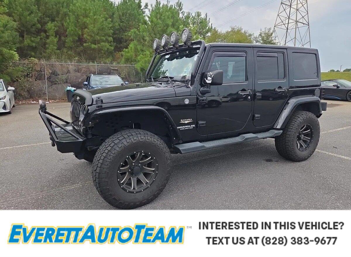 Used 2014 Black Clearcoat Jeep Sahara image 1