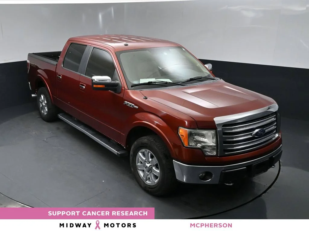 Used 2014 Orange Ford Lariat image 1