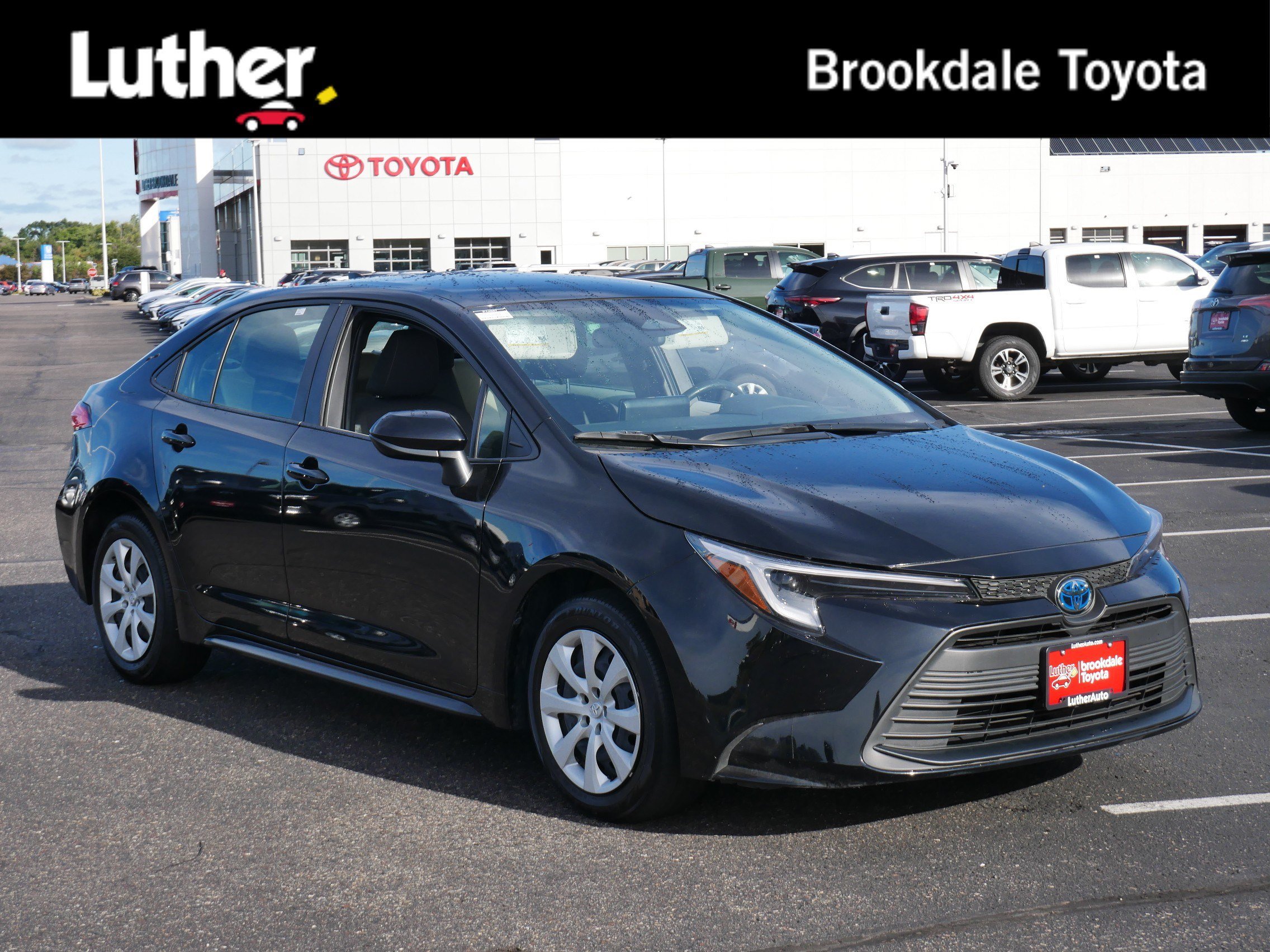 Used 2025 Midnight Black Metallic Toyota Hybrid LE image 1