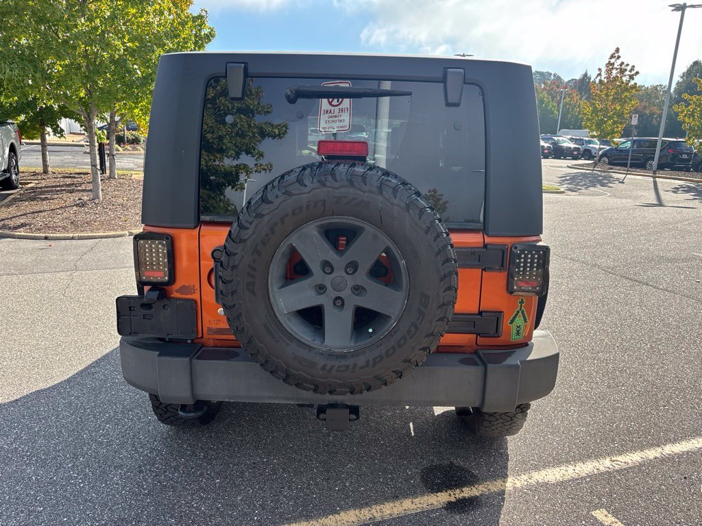 Used 2010 Orange Jeep Unlimited Sport image 5