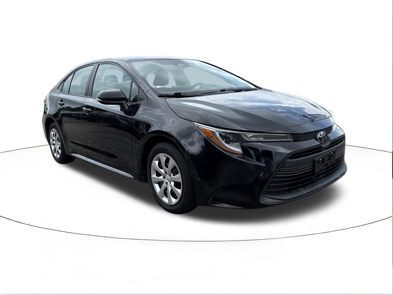 Used 2024 Midnight Black Metallic Toyota LE image 1