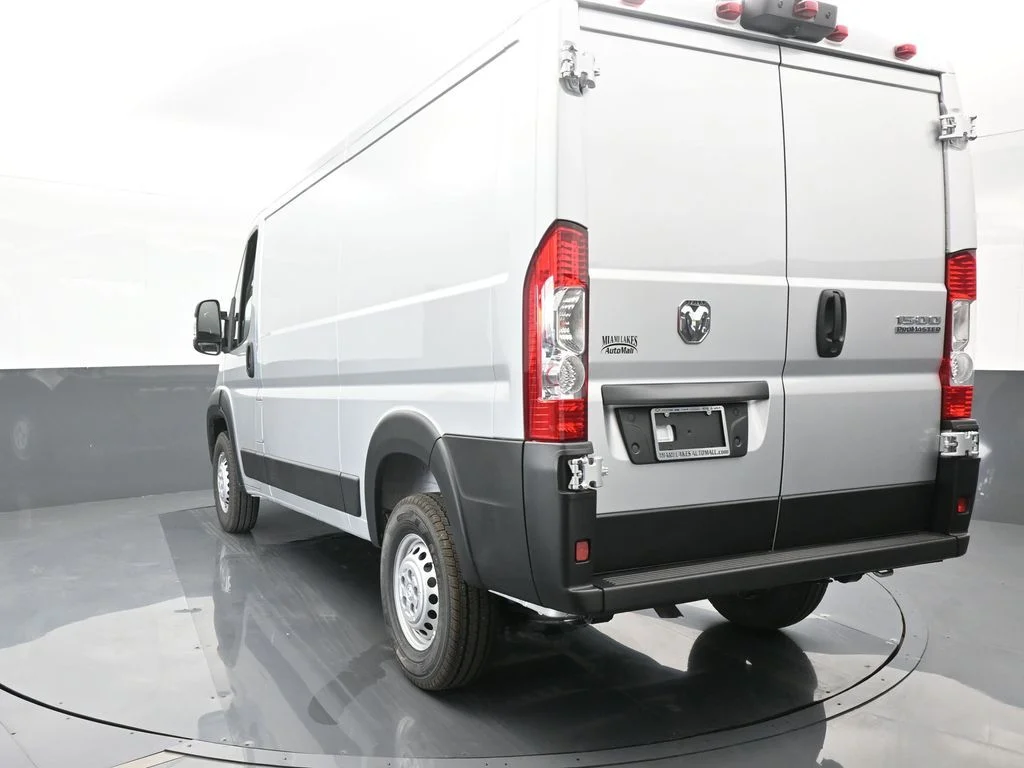 Used 2025 Bright Silver Clearcoat Metallic Ram Low Roof image 4