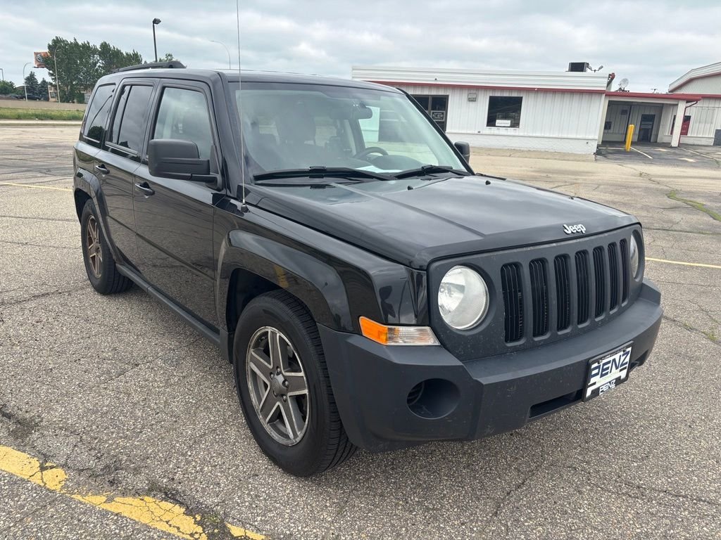 Used 2010 Black Jeep Sport image 1