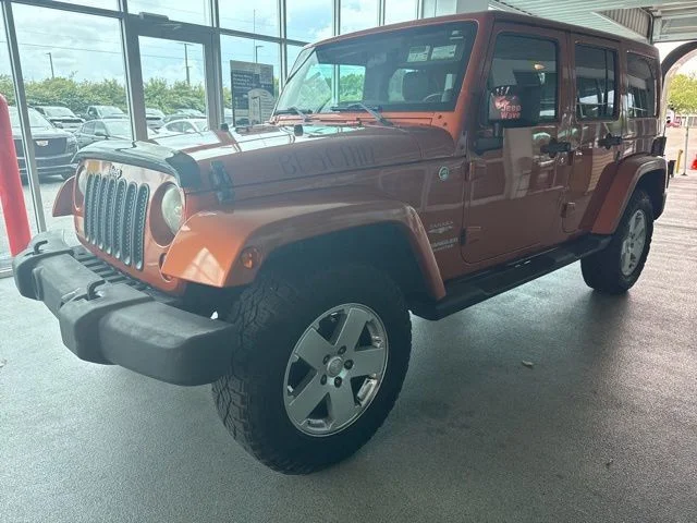 Used 2011 Orange Jeep Unlimited Sahara image 4