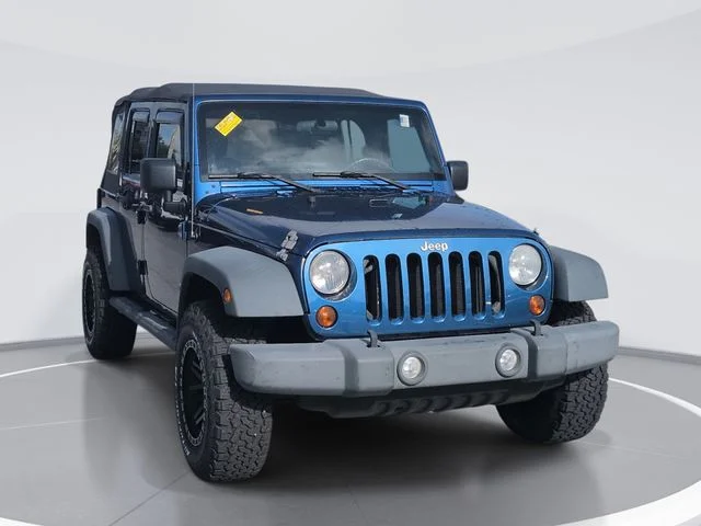 Used 2010 Blue Jeep Unlimited Sport image 1