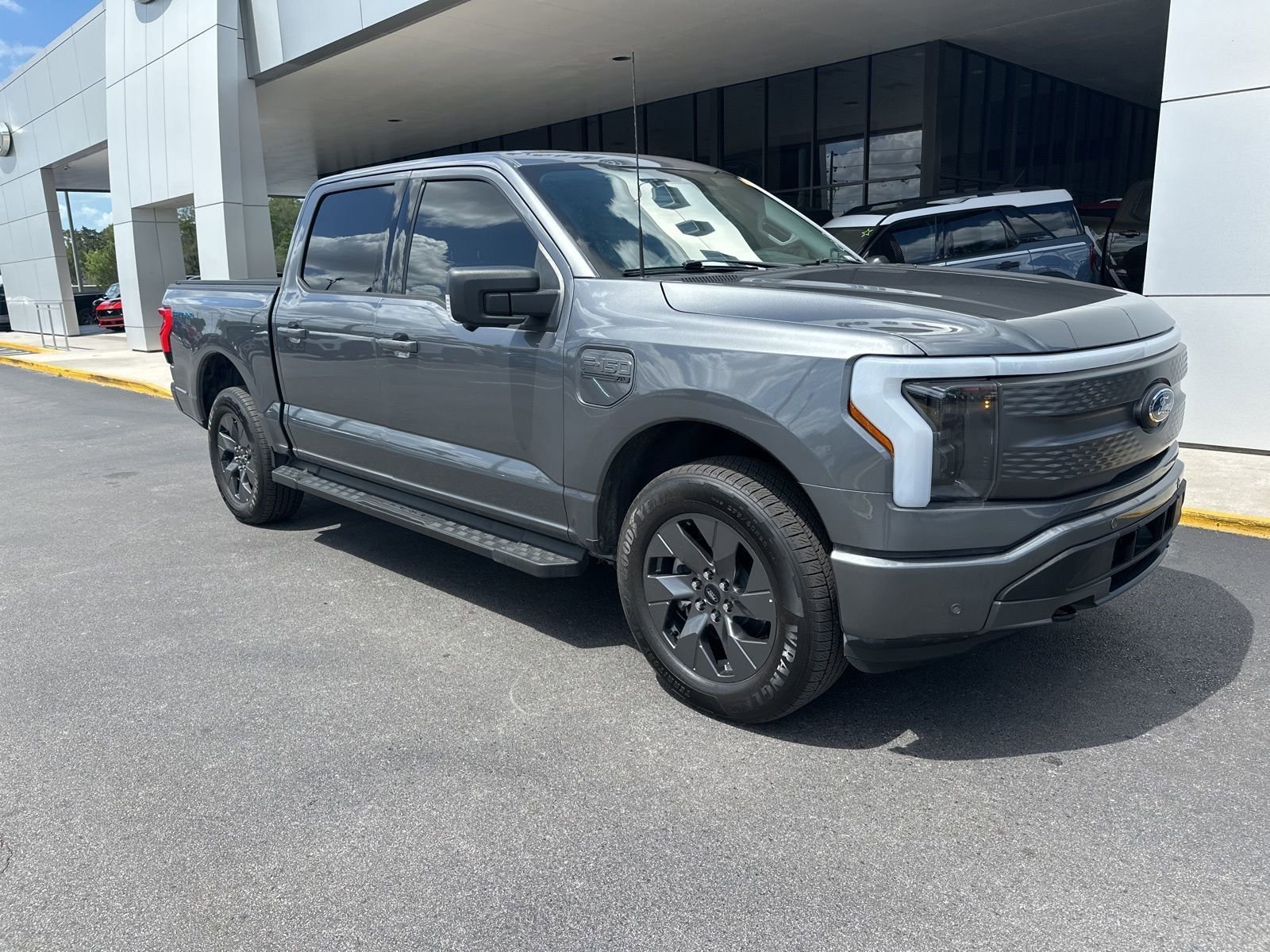 Used 2023 Ford F-150 Lightning XLT with VIN 1FT6W1EV7PWG26185 for sale in Spring Hill, FL