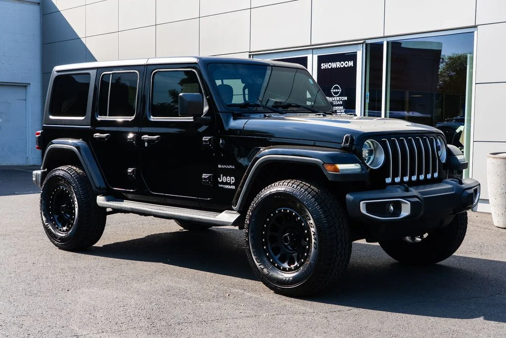 Used 2018 Black Jeep Unlimited Sahara image 1