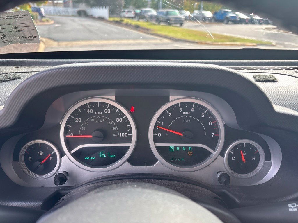 Used 2010 Orange Jeep Unlimited Sport image 12