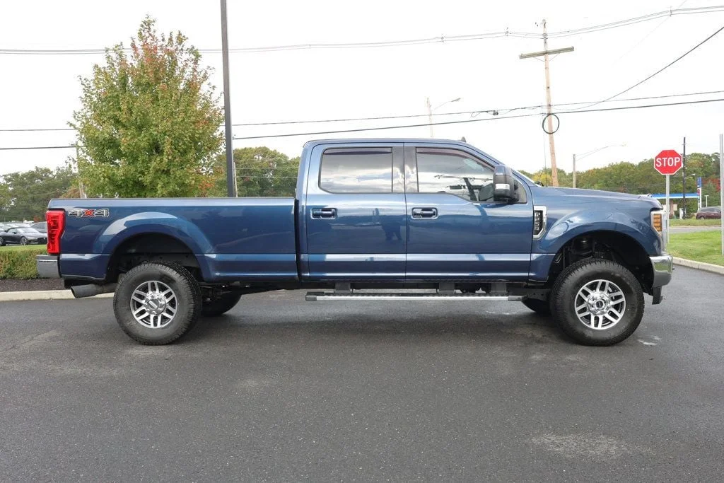 Used 2019 Blue Jeans Metallic Ford LARIAT 4WD Crew Cab 6.75