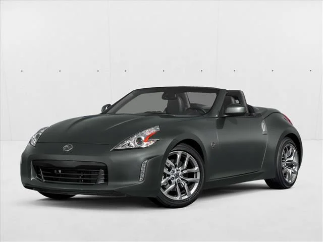 Used 2014 Black Cherry Metal Nissan  image 1