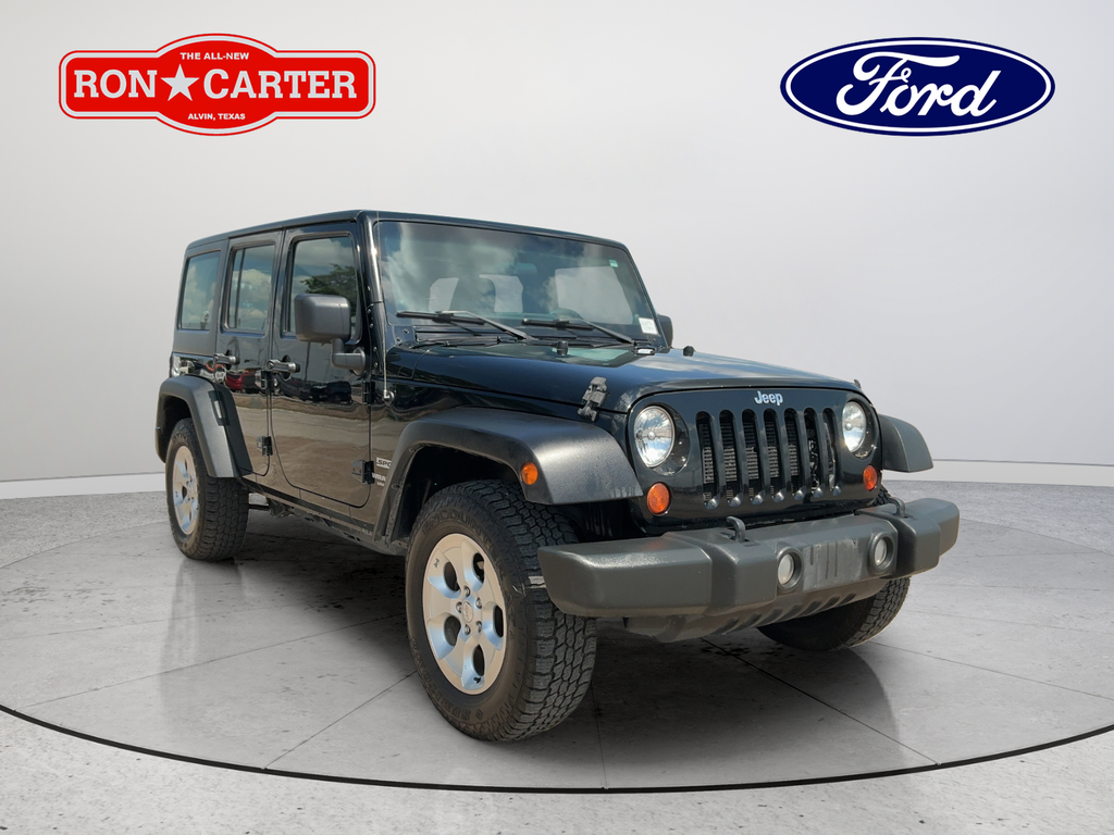 Used 2013 Black Jeep Unlimited Sport image 1