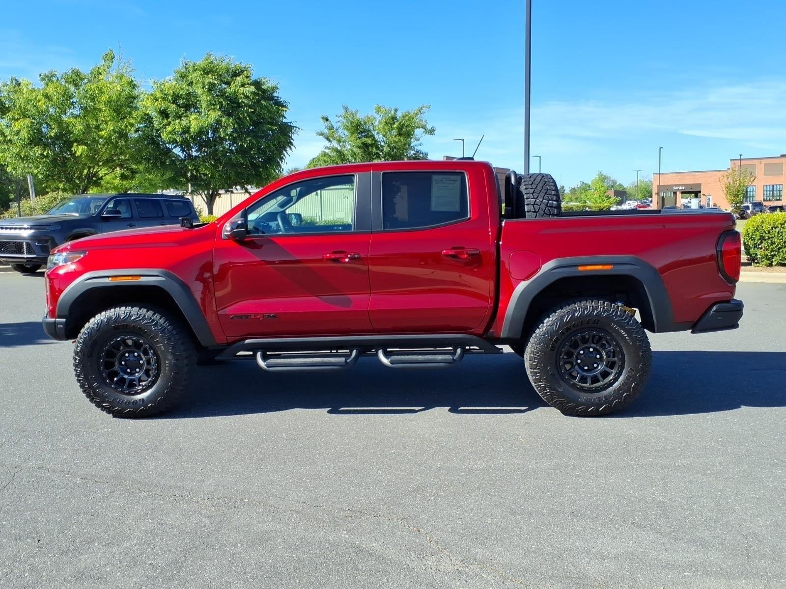 Used 2024 Volcanic Red Tintcoat GMC 4WD AT4X image 3