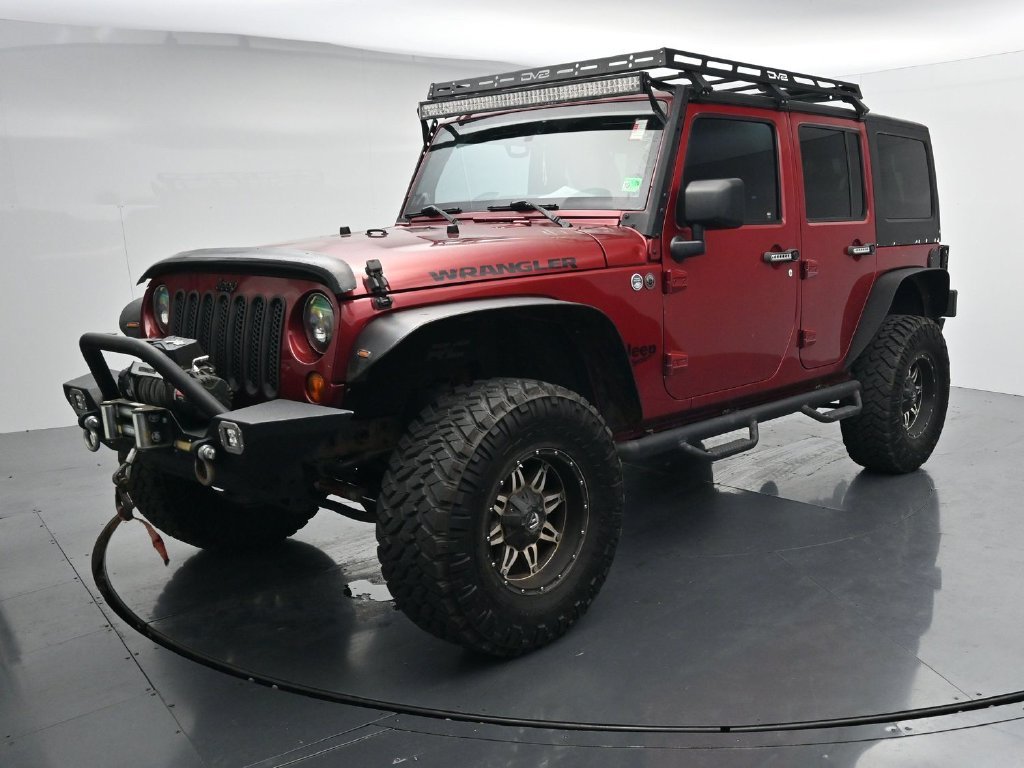 Used 2012 Red Jeep Unlimited Sport image 4
