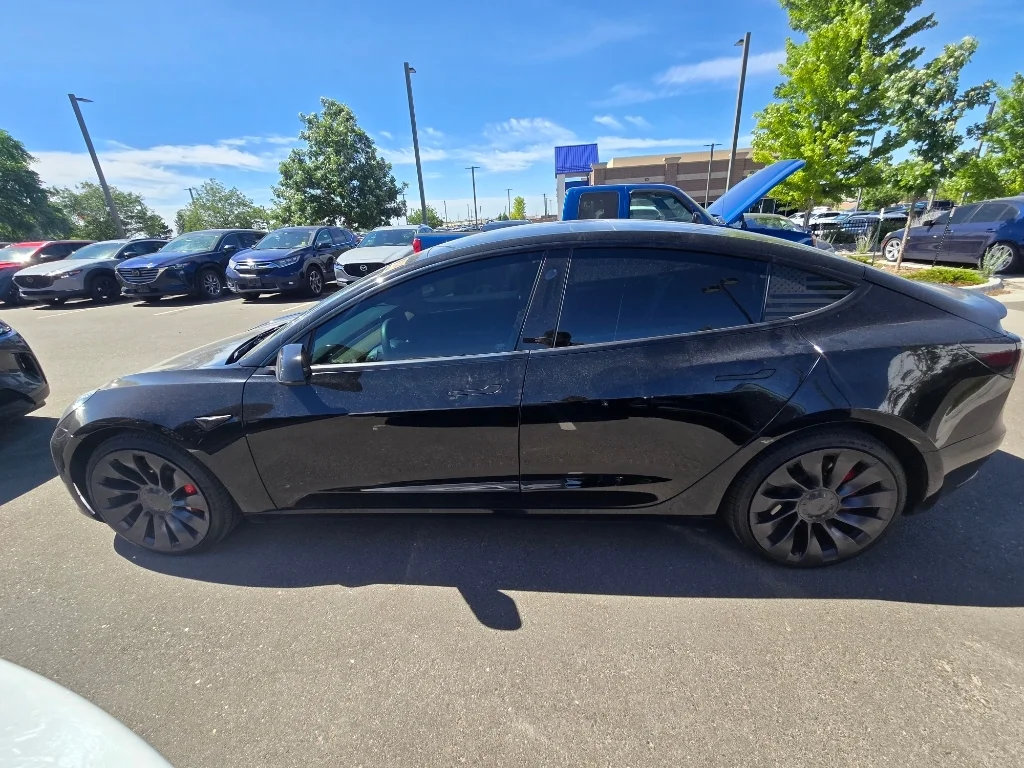 Used 2022 Solid Black Tesla Performance image 12