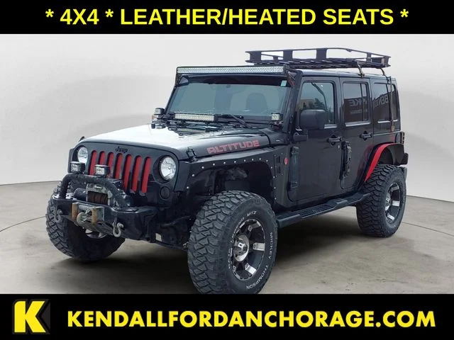 Used 2012 Black Jeep Unlimited Sahara Altitude image 1