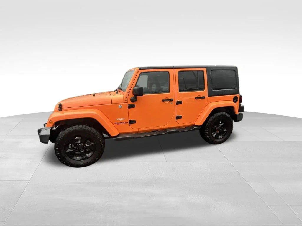 Used 2013 Orange Jeep Unlimited Sahara image 3