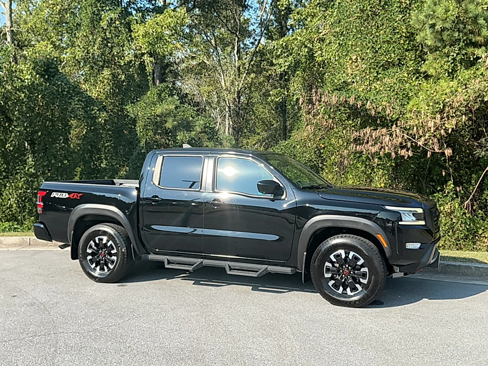 Used 2024 Super Black Nissan Crew Cab PRO-4X 4x4 image 1