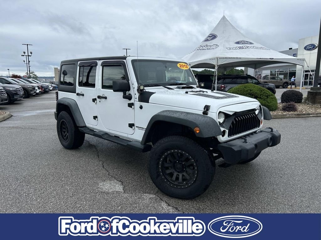 Used 2012 Bright White Jeep Unlimited Sport image 1