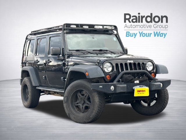Used 2012 Black Clearcoat Jeep Unlimited Sport image 1