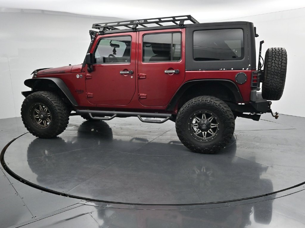 Used 2012 Red Jeep Unlimited Sport image 5