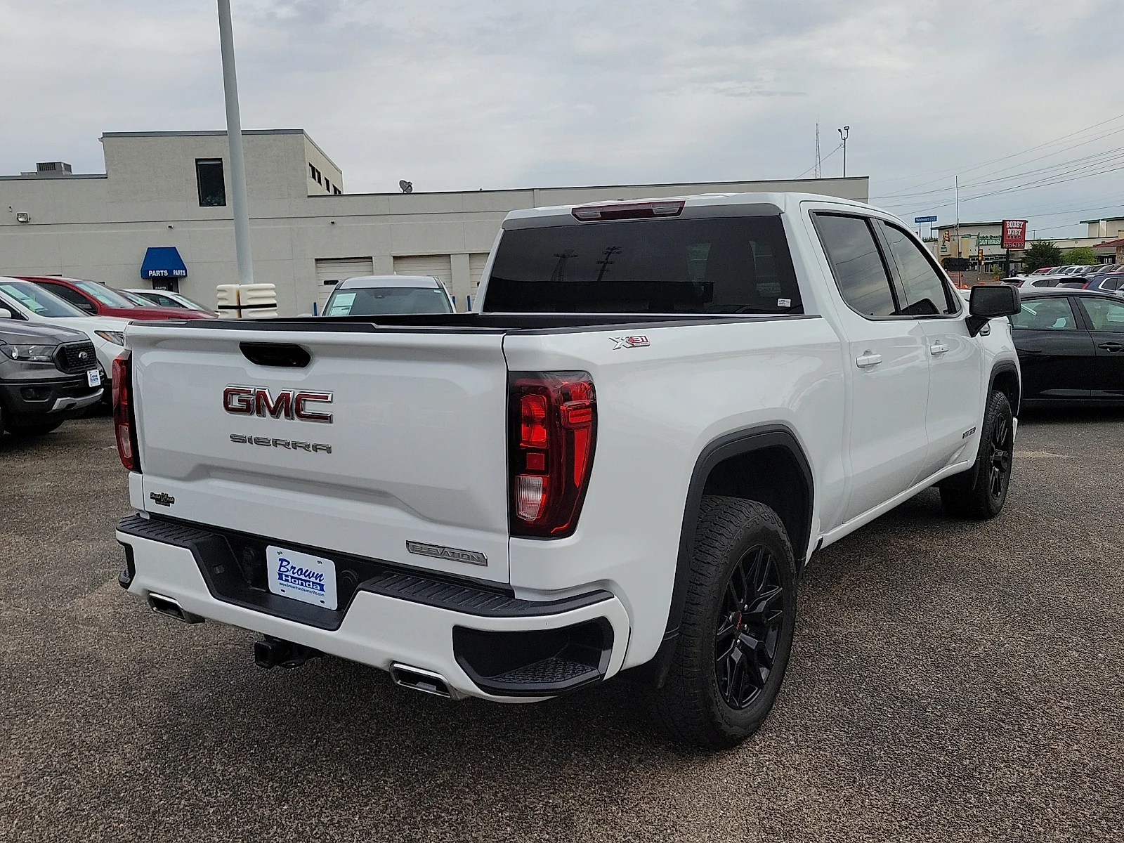 Certified Used 2024 Summit White GMC 4WD Crew Cab Short Box Elevation with 3SB image 10