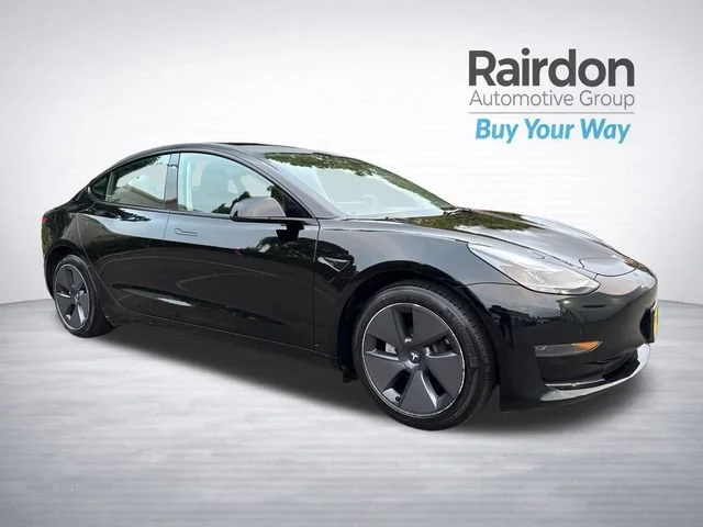 Used 2023 Solid Black Tesla Base image 1