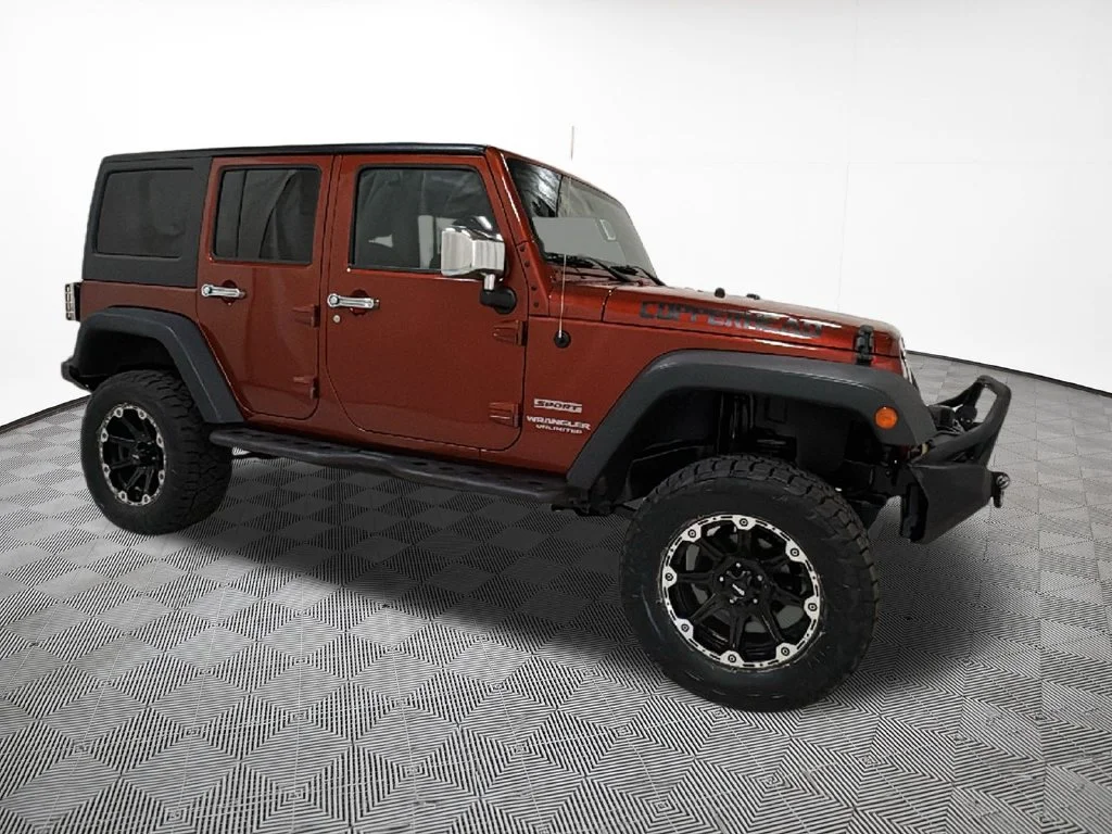 Used 2014 Orange Jeep Unlimited Sport image 5