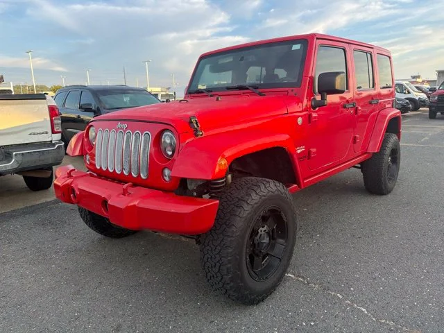 Used 2015 Red Jeep Unlimited Sahara image 1