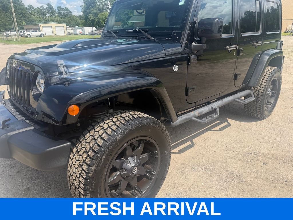 Used 2015 Black Jeep Unlimited Sahara Altitude image 1