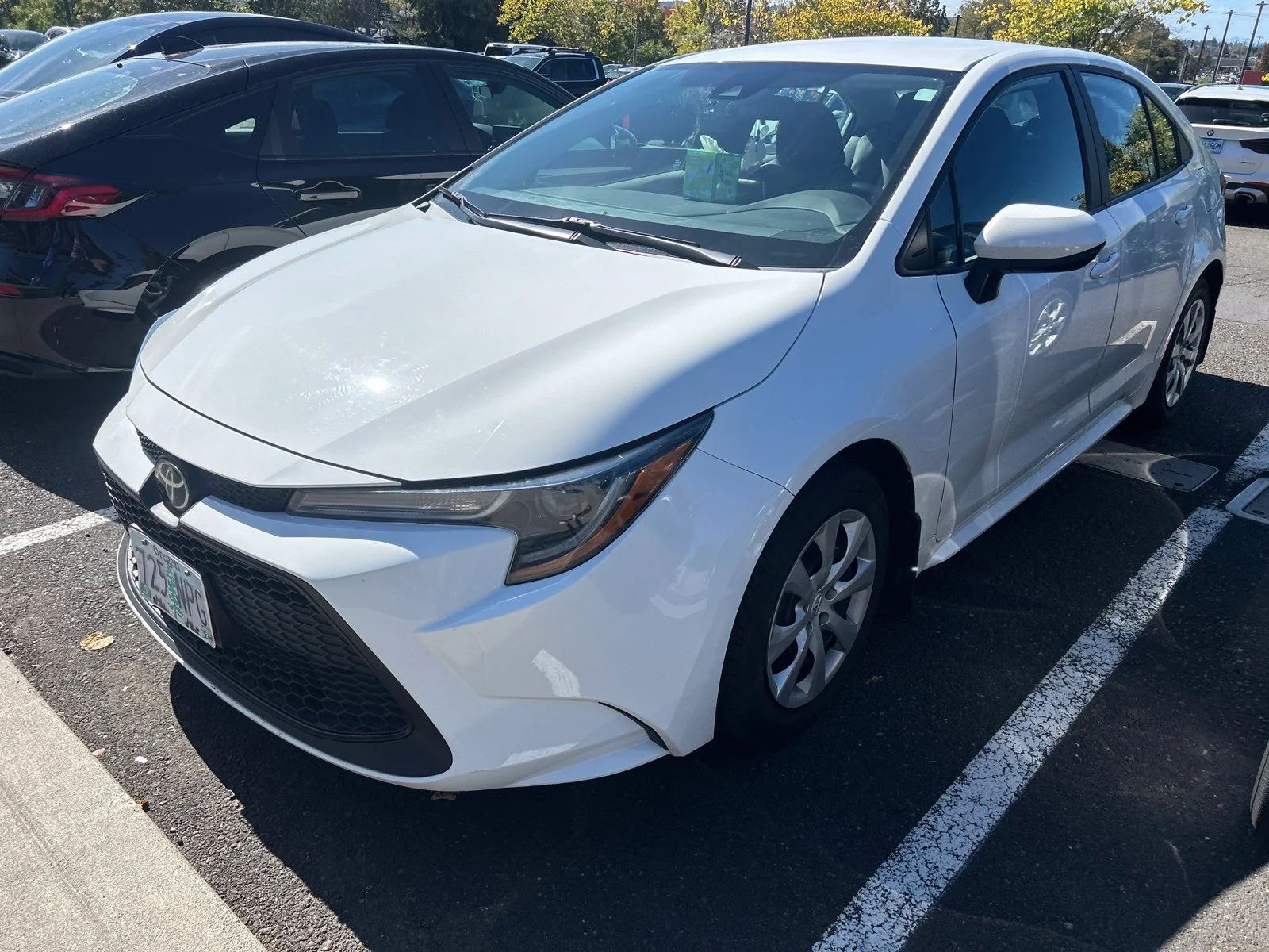Used 2021 Super White Toyota LE image 1