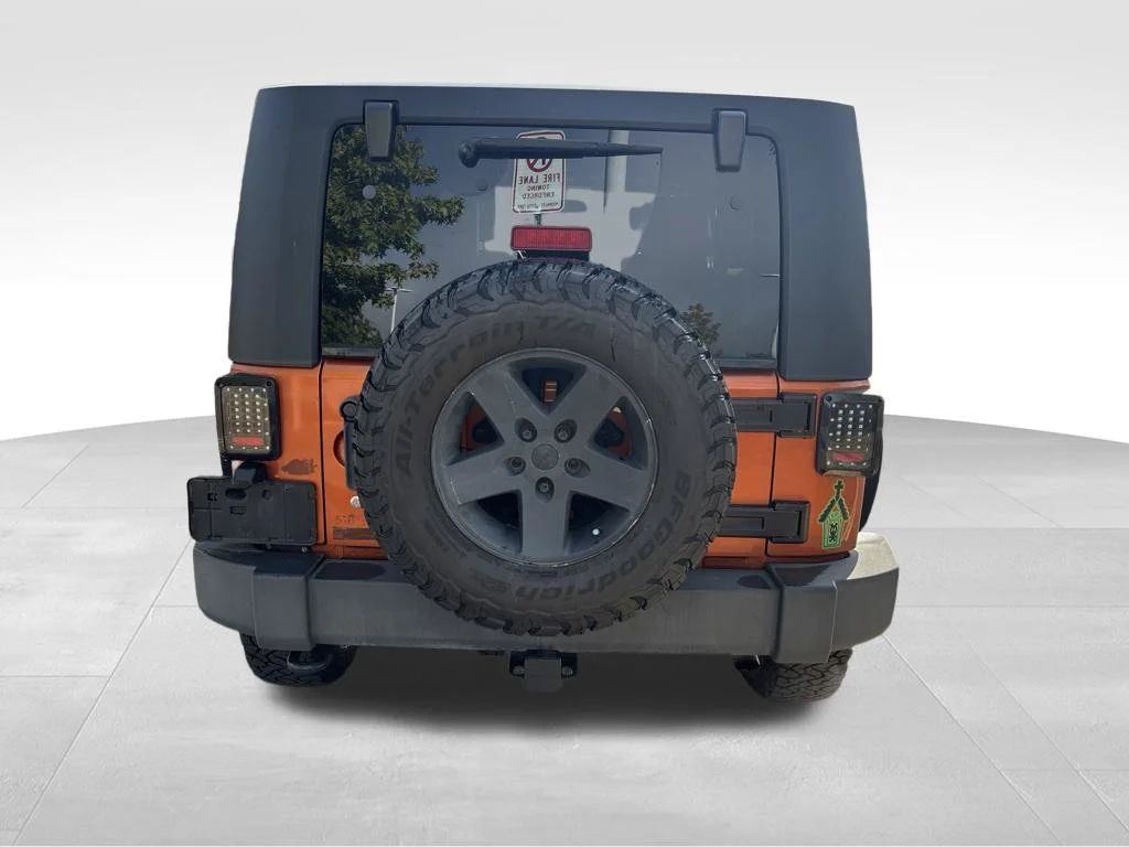 Used 2010 Orange Jeep Unlimited Sport image 5