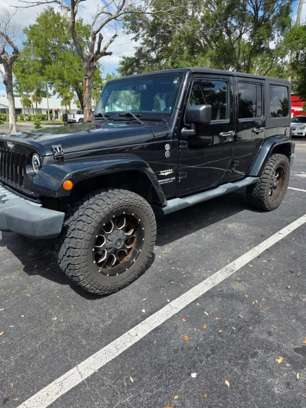 Used 2014 Black Jeep Unlimited Sahara image 1