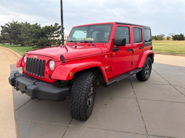 Used 2017 Red Jeep Unlimited Sahara image 1
