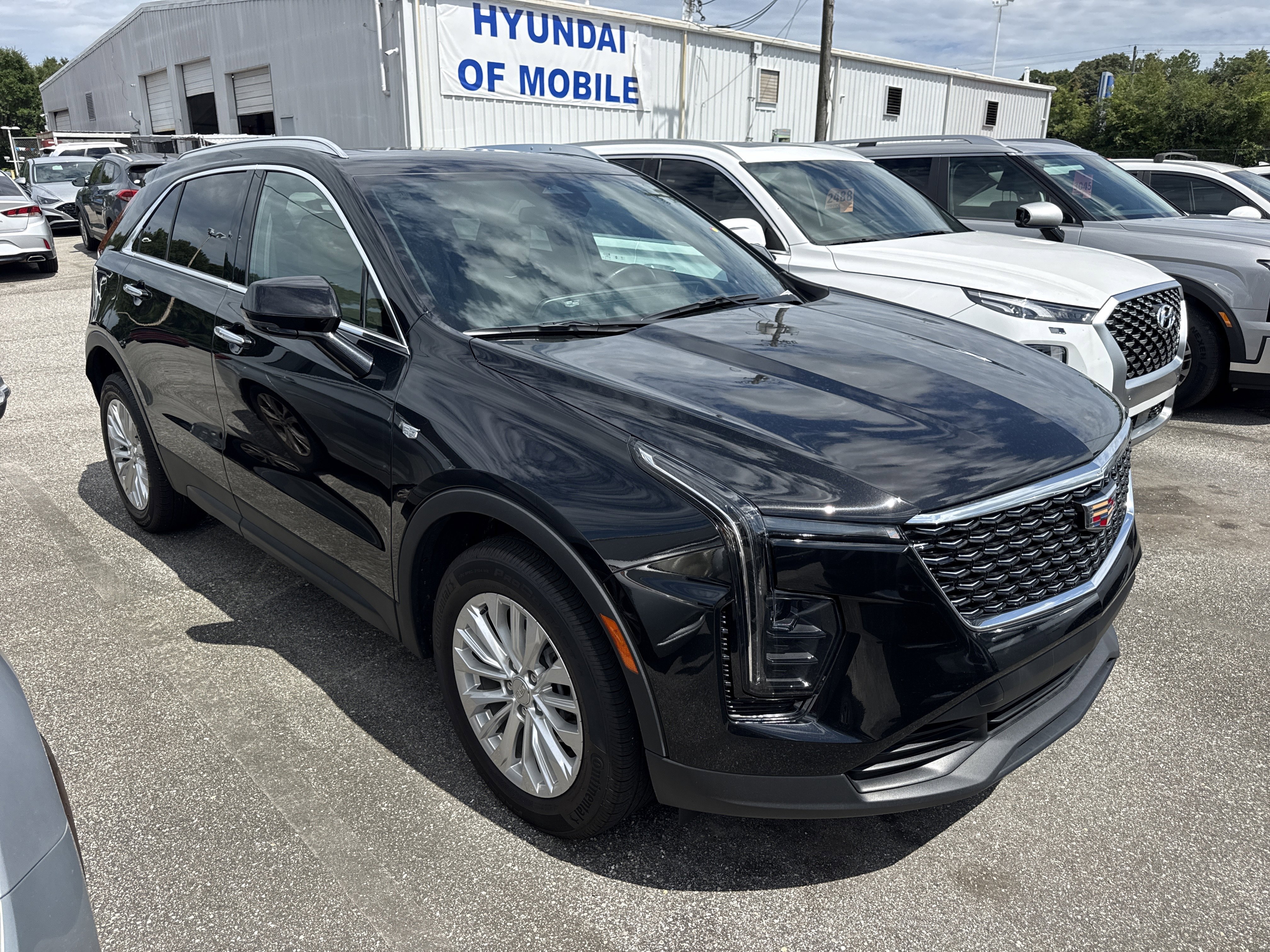 Used 2024 Stellar Black Metallic Cadillac AWD Luxury image 1