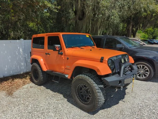 Used 2012 Orange Jeep Sahara image 1