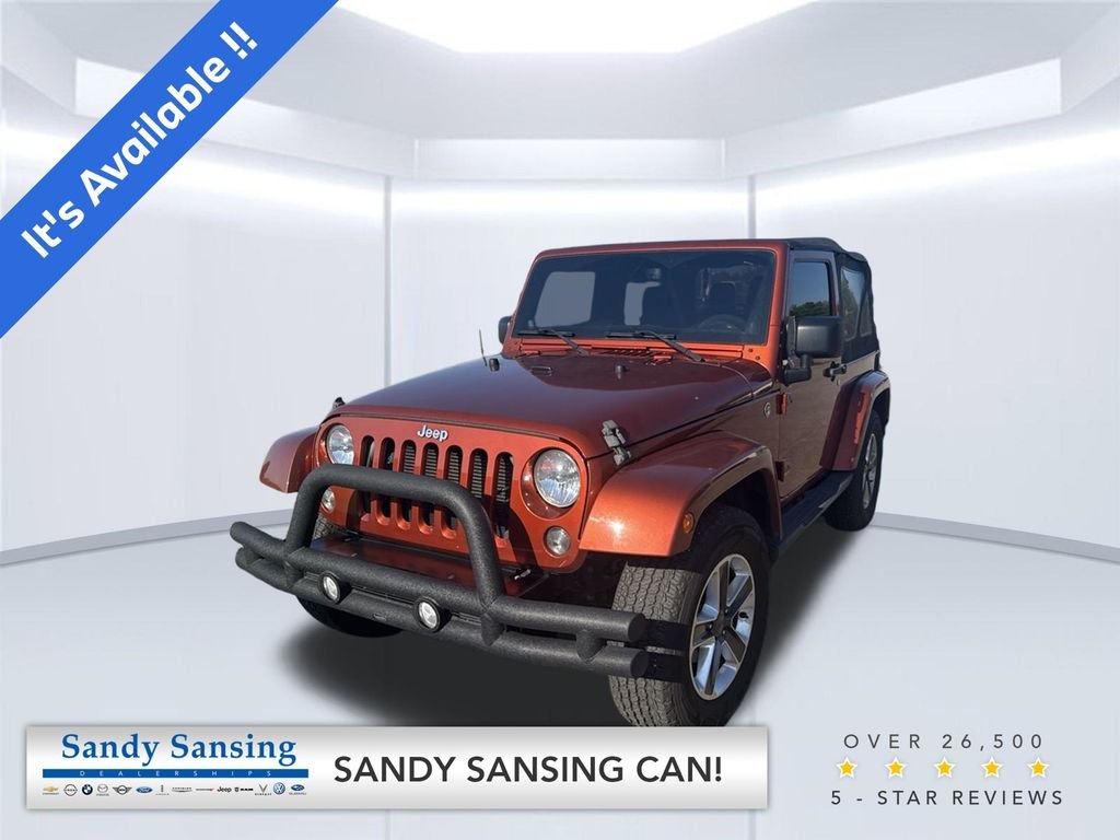 Used 2014 Orange Jeep Sahara image 1