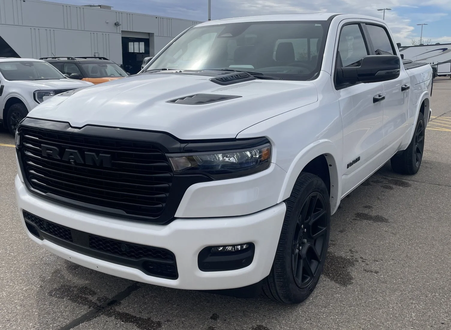 Used 2025 Ivory Tri-Coat Pearl Ram LARAMIE image 1