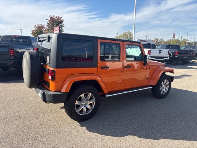 Used 2012 Orange Jeep Unlimited Sahara image 4