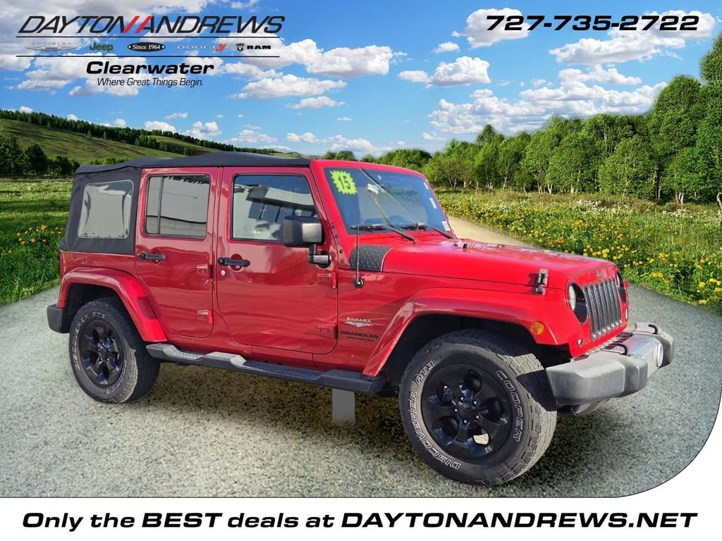 Used 2015 Red Jeep Unlimited Sahara image 1