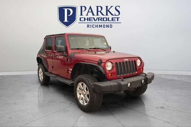 Used 2013 Red Jeep Unlimited Sahara image 1