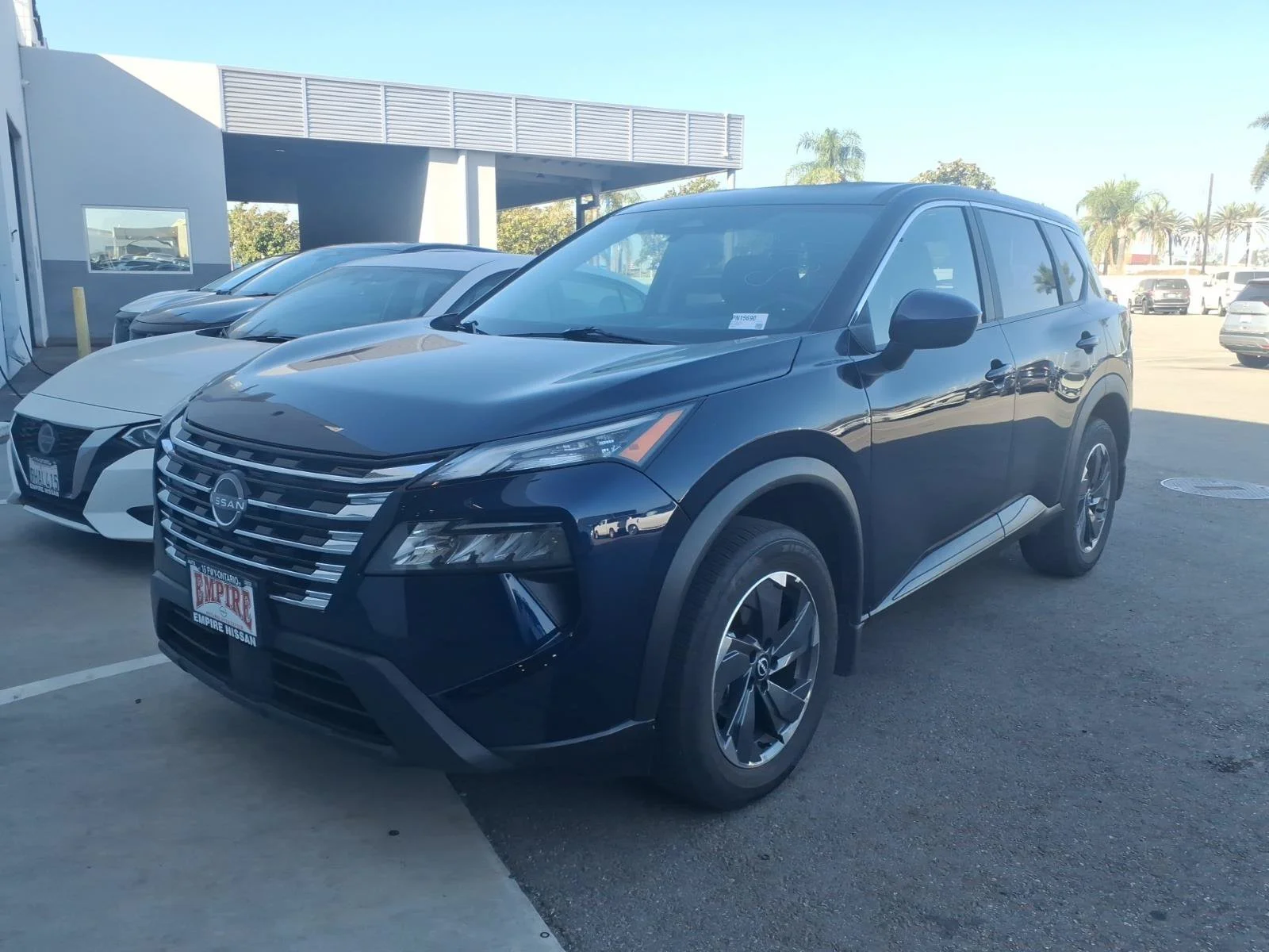 Certified Used 2025 Deep Ocean Blue Pearl Nissan SV image 1