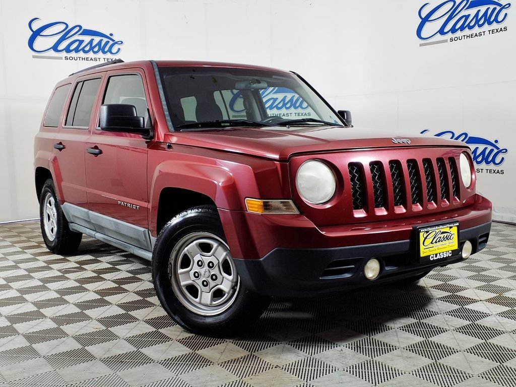 Used 2011 Deep Cherry Red Jeep Sport image 1