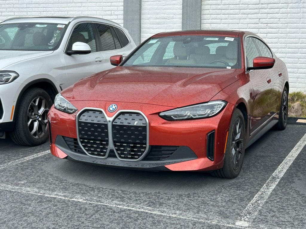 Certified Used 2023 Sunset Orange Metallic BMW eDrive40 image 2