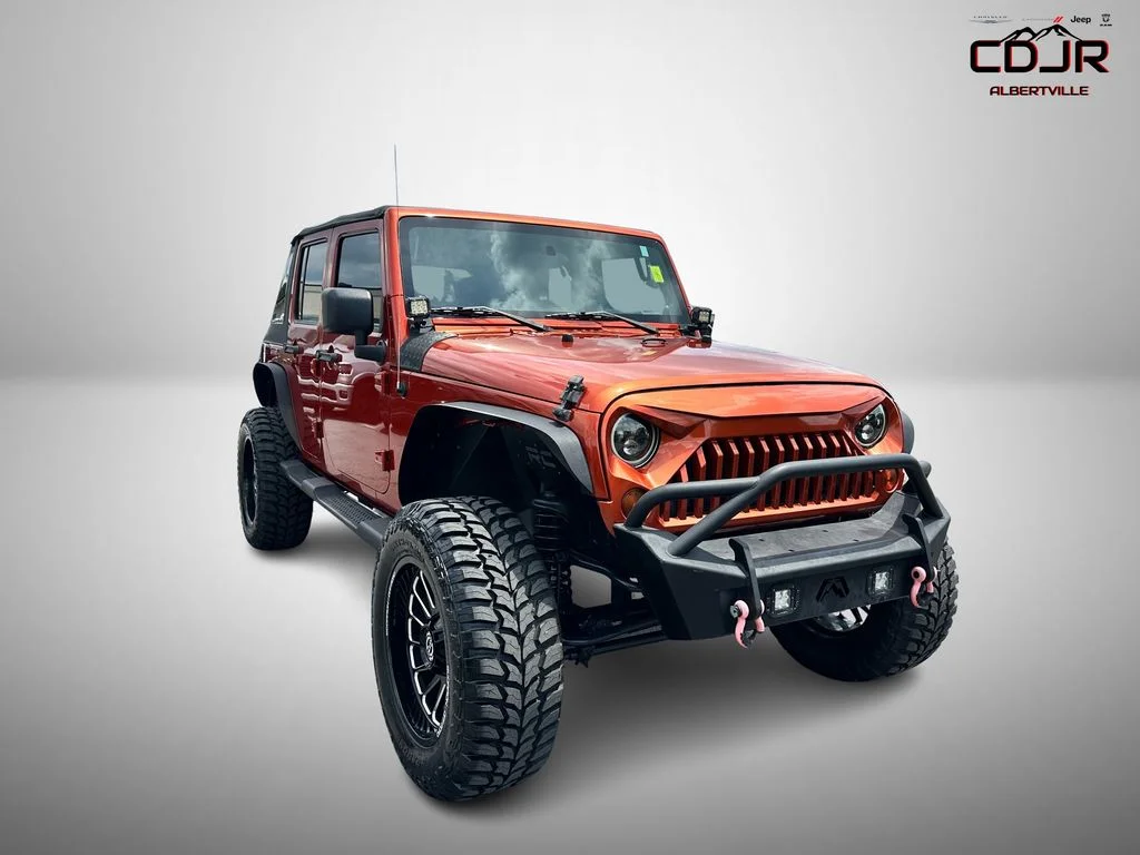 Used 2009 Orange Jeep Unlimited X image 1