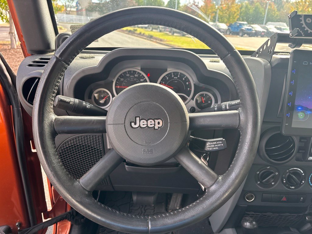 Used 2010 Orange Jeep Unlimited Sport image 11