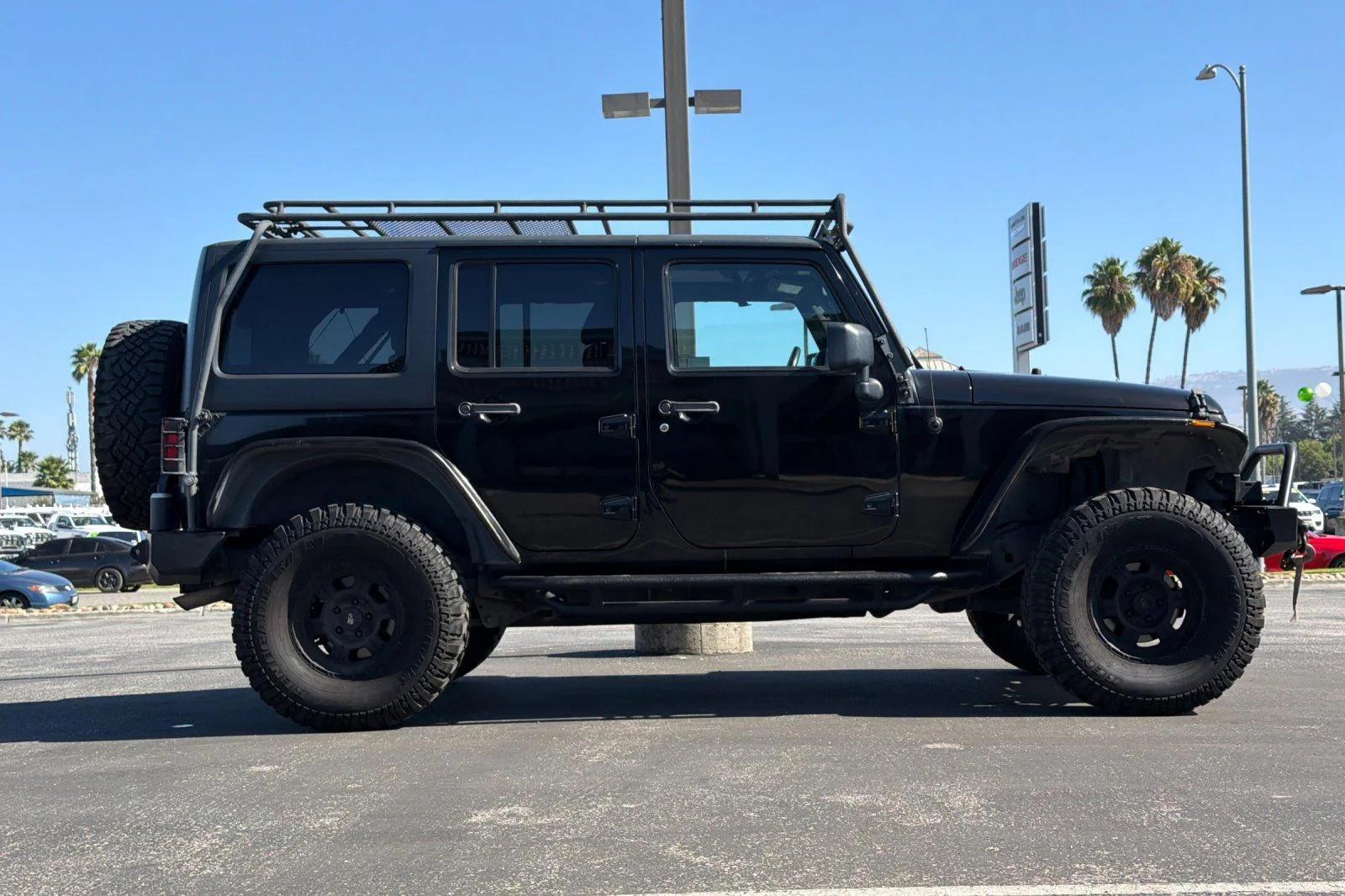 Used 2013 Black Jeep Unlimited Sport image 3