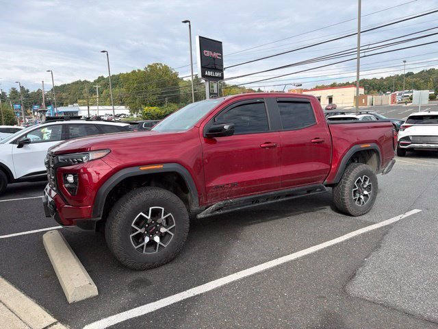 Used 2024 Volcanic Red Tintcoat GMC 4WD AT4X image 2