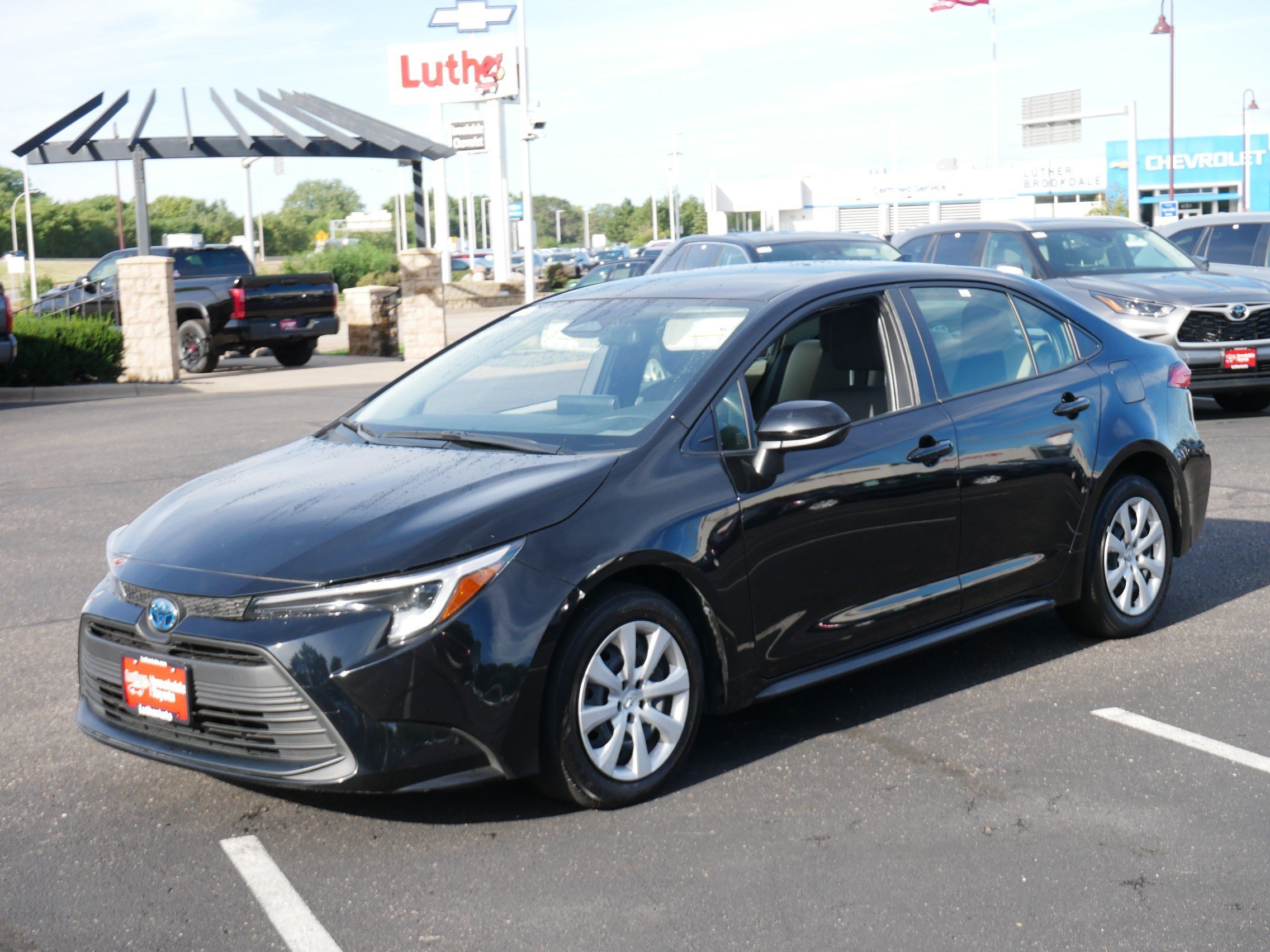 Used 2025 Midnight Black Metallic Toyota Hybrid LE image 3