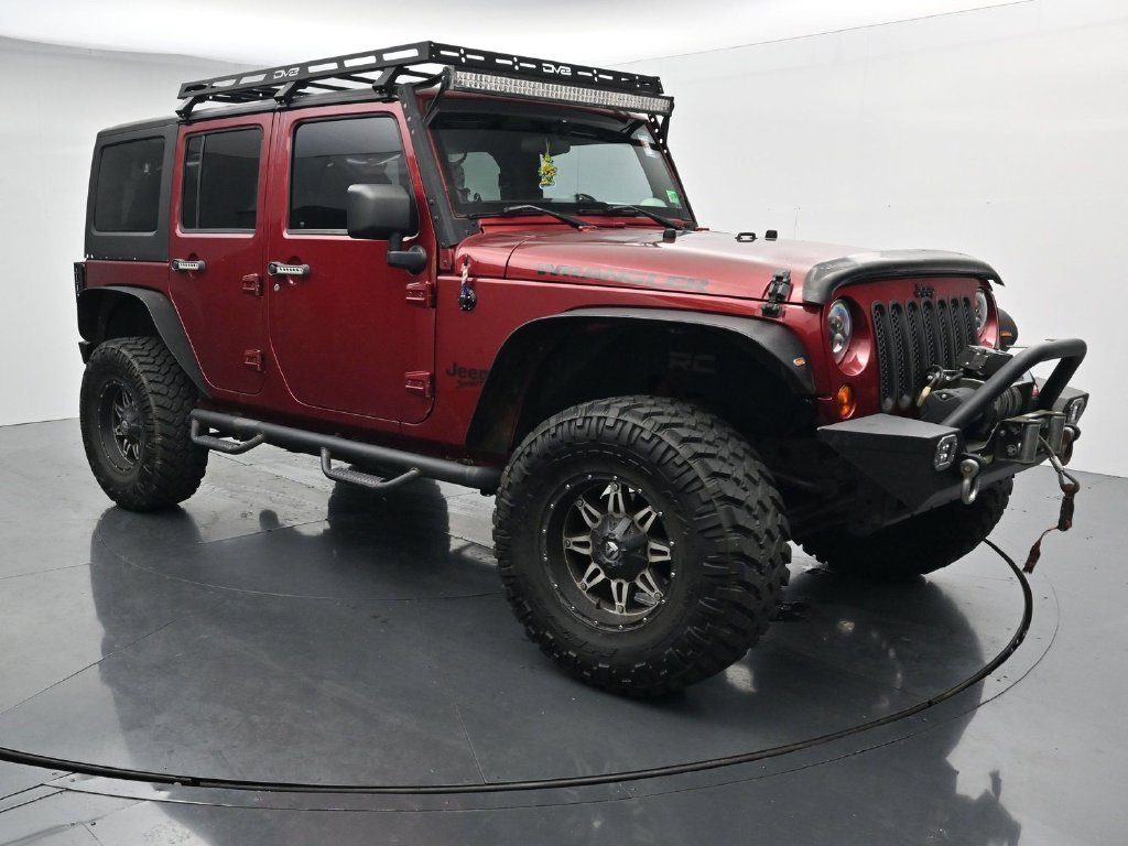 Used 2012 Red Jeep Unlimited Sport image 2